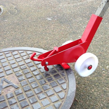 Manhole cover opener with wheels